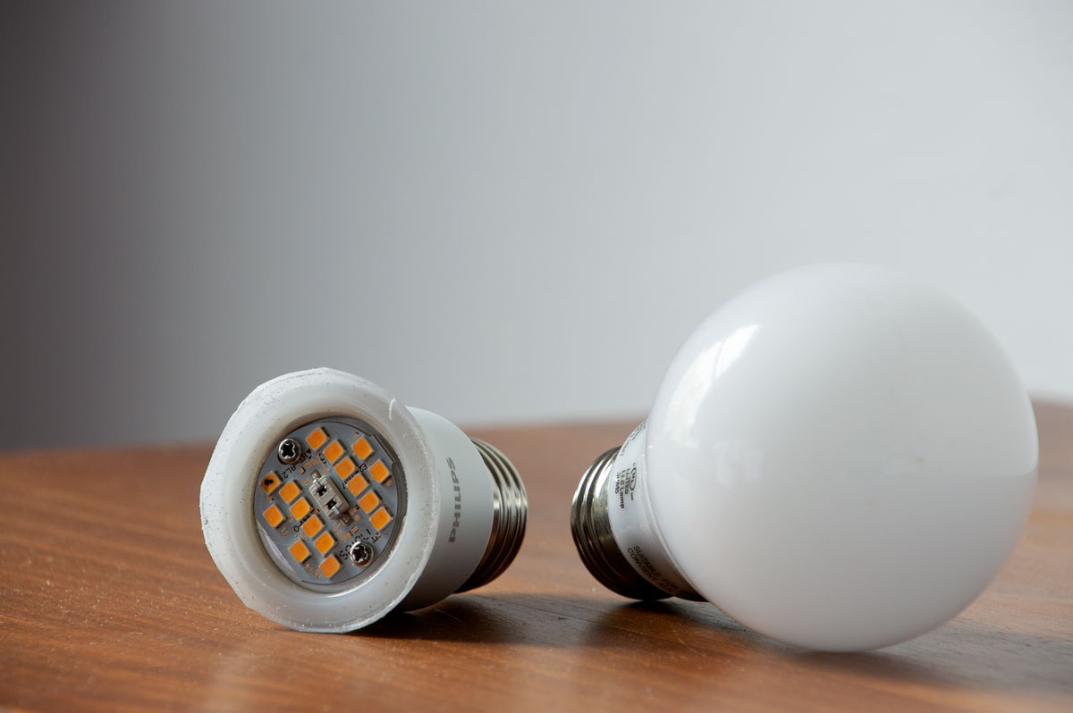 Two LED bulbs with the shade of one bulb removed to expose the diodes and circuit board.